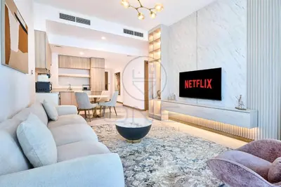 a living room with a couch and a tv at Premium 2BR Apartment at Urban Oasis, Business Bay in Dubai