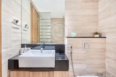 a bathroom with a white sink and a mirror at Premium 2BR Apartment at Urban Oasis, Business Bay in Dubai