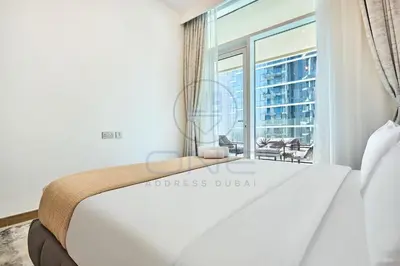 a bedroom with a bed and a large window at Premium 2BR Apartment at Urban Oasis, Business Bay in Dubai