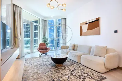 a living room with a couch and a table at Premium 2BR Apartment at Urban Oasis, Business Bay in Dubai