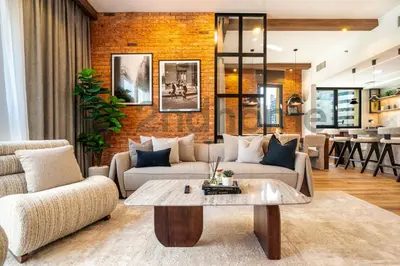 a living room with two couches and a brick wall at Luxurious Newly Furnished 2 Bed in Dubai Marina in Dubai