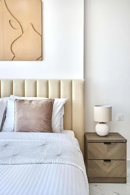 a bedroom with a bed and a lamp on a nightstand at Frank Porter - Adhara Star in Dubai