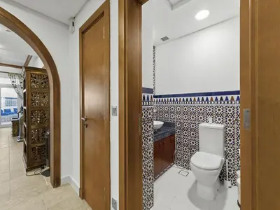a bathroom with a toilet and a sink at DVH Al Basri Palm Beachfront 2BR Full Sea Views in Dubai