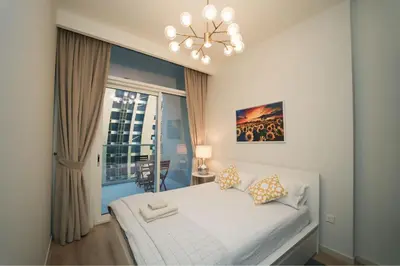 a bedroom with a white bed and a window at Luxury 2BR in Business Bay Close to Dubai Mall in Dubai