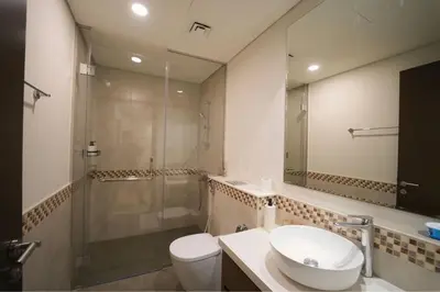 a bathroom with a toilet and a sink and a shower at Luxury 2BR in Business Bay Close to Dubai Mall in Dubai