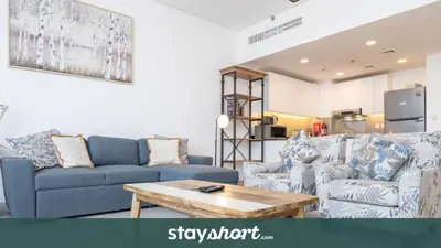 a living room with two couches and a coffee table at StayShort - Cozy 2 Bedroom Retreat in Dubai South Close to Expo 2020 in Dubai Marina