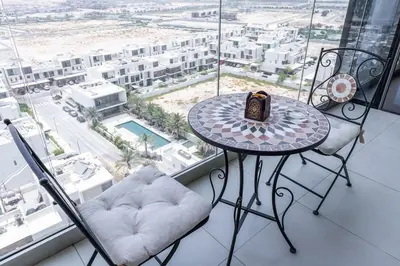a table and chairs in a room with a view of a city at StayShort - Cozy 2 Bedroom Retreat in Dubai South Close to Expo 2020 in Dubai Marina