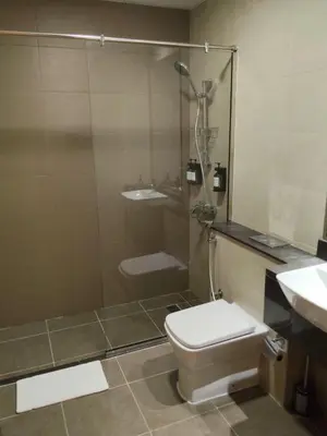 a bathroom with a shower and a toilet and a sink at Deluxe Apartments Near WTC and Sheikh Zayed in Dubai