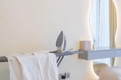 a mirror and a table with a towel on it at Brand New 1BR - Burj View - Infinity Pool - Dubai Mall in Dubai