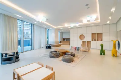 a living room with a large room with tables and chairs at Brand New 1BR - Burj View - Infinity Pool - Dubai Mall in Dubai