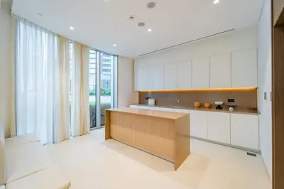 a kitchen with white cabinets and a large window at Brand New 1BR - Burj View - Infinity Pool - Dubai Mall in Dubai