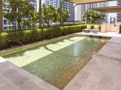 a swimming pool in the middle of a building at Beachfront Luxury 1BR with Private Beach, Marina & Sea Views in Dubai