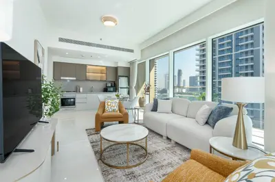 a living room with a couch and a table at Beachfront Luxury 1BR with Private Beach, Marina & Sea Views in Dubai