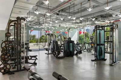 a gym with a lot of treadmills and machines at Chic Studio Steps to Dubai Mall with Infinity Pool in Dubai