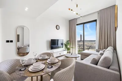 a living room with a couch and a table at Stylish 1-Bedroom Apartment in JVC Dubai in Dubai