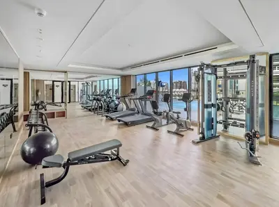 an apartment gym with treadmills and cardio machines at Stylish 1-Bedroom Apartment in JVC Dubai in Dubai