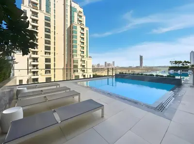 a swimming pool on the roof of a building at Stylish 1-Bedroom Apartment in JVC Dubai in Dubai