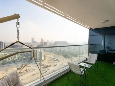 a room with two chairs and a large window at Opalz Serenity Designer- 1BDR Retreat-07 in Dubai
