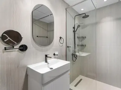 a bathroom with a sink and a mirror and a shower at Opalz Serenity Designer- 1BDR Retreat-07 in Dubai
