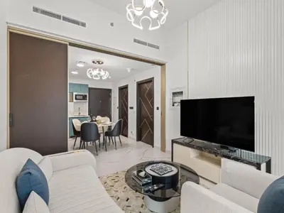 a living room with a couch and a tv at Opalz Serenity Designer- 1BDR Retreat-07 in Dubai