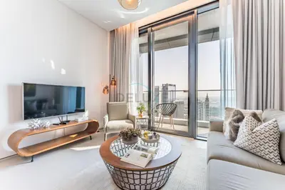 a living room with a couch and a large window at Balcony Facing the Marina with Partial Sea Views, Steps from the Beach and a Short Walk to Ain Dubai and Tram, The Address Residences, Jumeirah Beach Residence by Deluxe Holiday Homes in Dubai