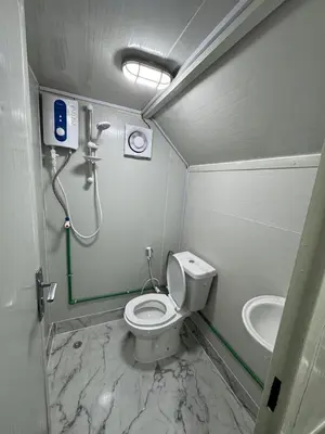a small bathroom with a toilet and a shower at dubai camp in ‘Ūd al Bayḑāʼ