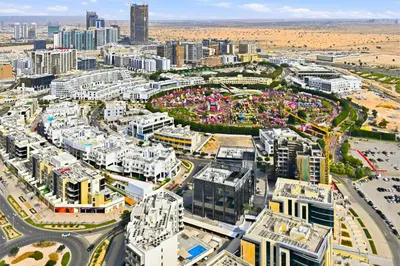 an aerial view of a city with tall buildings at Luxury studio Near Miracle Garden with Gym & Pool in Dubai
