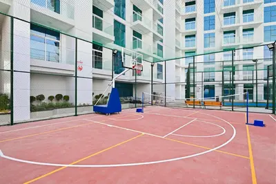 a basketball court in a building with a basketball hoop at Luxury studio Near Miracle Garden with Gym & Pool in Dubai
