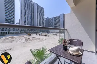 a balcony with a table with a hat on it at Vogue Downtown The Sterling by Omniyat, near Burj Khalifa and Dubai Mall, Studio Apartment with Balcony and Access to all Amenities in Dubai