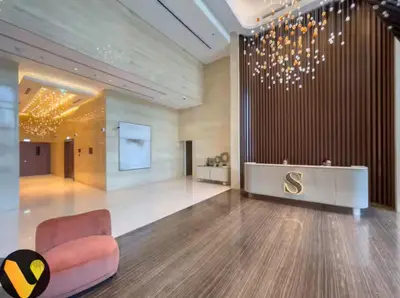 a lobby with a chair and a reception desk at Vogue Downtown The Sterling by Omniyat, near Burj Khalifa and Dubai Mall, Studio Apartment with Balcony and Access to all Amenities in Dubai