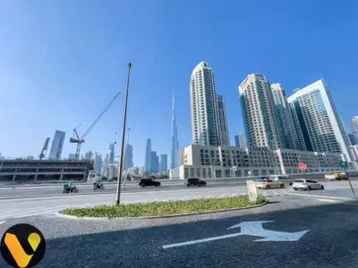a city with tall buildings and a highway with cars at Vogue Downtown The Sterling by Omniyat, near Burj Khalifa and Dubai Mall, Studio Apartment with Balcony and Access to all Amenities in Dubai