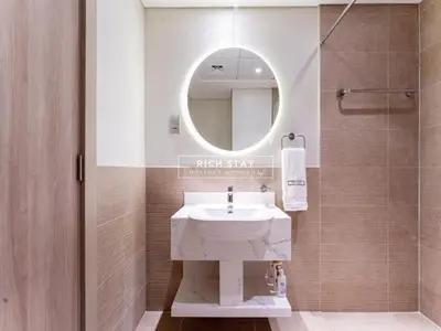 a bathroom with a sink and a mirror at Sway Retreat 1BR Apartment with Burj Khalifa View in Dubai