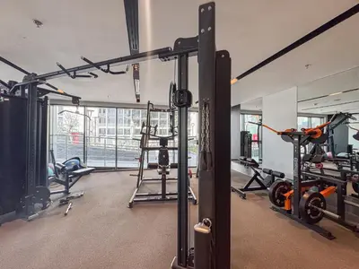 a gym with treadmills and machines in a room at Comfortable 2BR Near Downtown by Czechin in Dubai