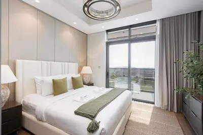 a bedroom with a large bed and a large window at Comfortable 2BR Near Downtown by Czechin in Dubai