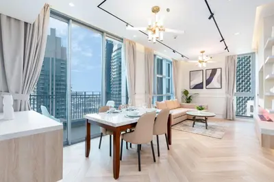 a dining room and living room with a table and chairs at Burj Khalifa View 5 Min walk to Dubai Mall in Dubai
