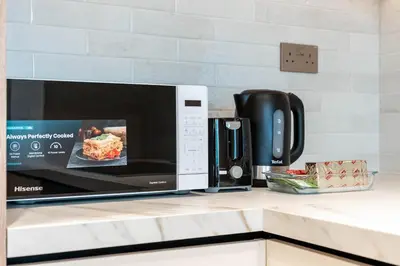 a microwave oven sitting on a kitchen counter at Burj Khalifa View 5 Min walk to Dubai Mall in Dubai