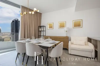 a dining room with a table and chairs at LUX The Dubai Marina Skyline Suite 2 in Dubai