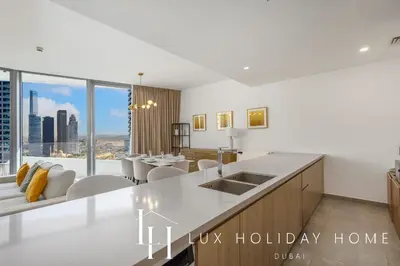 a kitchen with a white counter top and a large window at LUX The Dubai Marina Skyline Suite 2 in Dubai