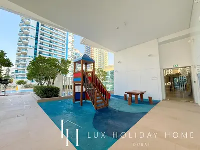 a building with a playground in the middle of a lobby at LUX The Dubai Marina Skyline Suite 2 in Dubai