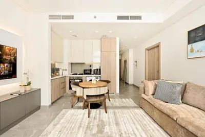 a living room with a couch and a table at Curated High-Floor 1BR Water View Peninsula 1 in Dubai