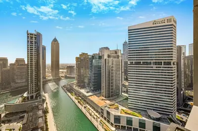 a view of a river in a city with tall buildings at Curated High-Floor 1BR Water View Peninsula 1 in Dubai