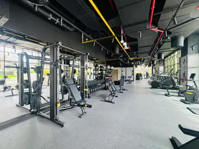 a gym with rows of treadmills and machines at Curated High-Floor 1BR Water View Peninsula 1 in Dubai