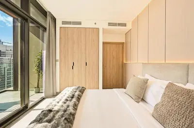 a bedroom with a large bed and a large window at Curated High-Floor 1BR Water View Peninsula 1 in Dubai
