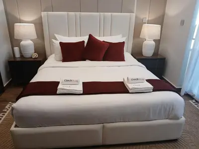 a bedroom with a large bed with red pillows at Luxury 2BR Nobles Tower Business Bay by Czechin in Dubai