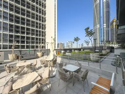 a patio with a table and chairs and buildings at Luxury 2BR Nobles Tower Business Bay by Czechin in Dubai