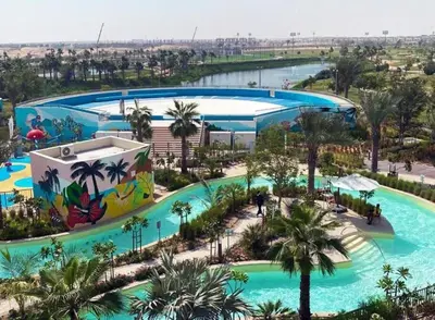 an overhead view of a pool at a resort at 1 BR luxury flat Damac hills2 in ‘Ūd al Bayḑāʼ