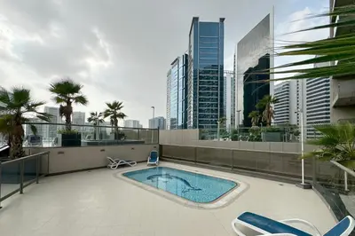 a swimming pool on the roof of a building at Elite Downtown Studio with Balcony & Pool in Dubai