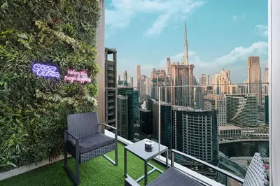 a balcony with a view of a city skyline at High Rise Premium 2BR apt, PS5, Burj Khalifa view. in Dubai
