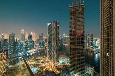 a view of a city skyline at night at High Rise Premium 2BR apt, PS5, Burj Khalifa view. in Dubai