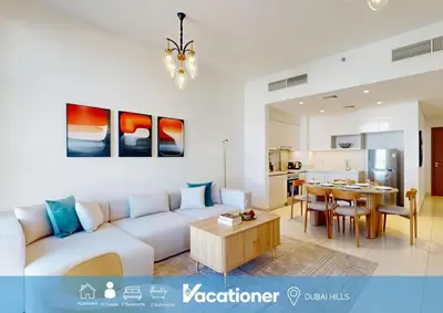 a living room with a couch and a table at Vacationer l Vibrant 2 Bed l Dubai Hills Mall l Free Pool, Gym in Dubai